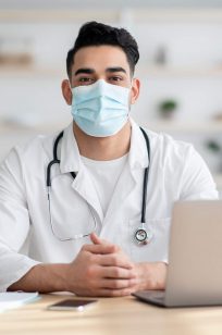 doctor-in-face-mask-working-on-laptop-2021-09-02-17-15-33-utc.jpg